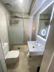 a white bathroom with a sink and a toilet at Hotel Flamingo in Lisbon +22 photos