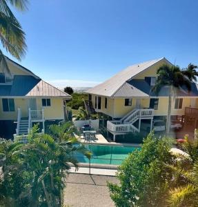 a house with a swimming pool in front of it at Seagrape Village 2 in Sanibel