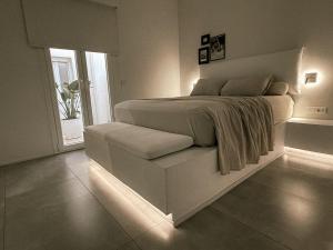 a bedroom with a bed with a lightedvisorvisoromaly at AELIA Tinos in Tinos