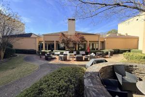 a building with chairs and tables in a courtyard at Hotel Preston by IHG in Montgomery