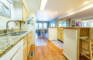 a kitchen with a sink and a counter top at Fly Boys - Nags Head MP 12.5, Oceanfront, Ocean View, Elevator, Pool Table, Hot Tub, YR Flex in Nags Head