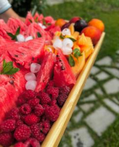 a tray of fruit on a wooden plate at Sunny Village Hotel in Haghpat