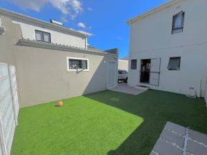 a yard with a soccer ball on the grass at Valley Escape in Cape Town