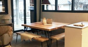 a dining room table with a vase on top of it at Chezgege in Valloire