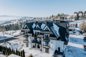 an aerial view of a house in the snow at Willa Janowa & SPA in Bukowina Tatrzańska