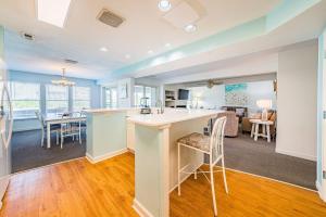 a kitchen and living room with a kitchen and a dining room at Dunes for Days - Nags Head MP 12.5, Oceanfront, Hot Tub, Rec Room, Pets OK, YR Flex in Nags Head +57 photos