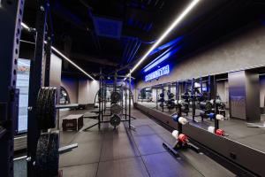 a gym with rows of equipment in a room at Wallesmanni - Nokia Arena by Come in! in Tampere