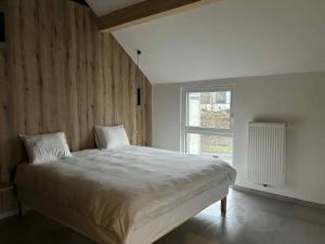 a bedroom with a large bed and a window at L'ancien rucher in Hotton +54 photos