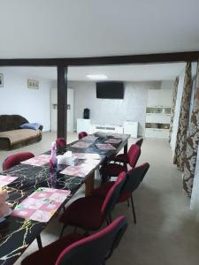 a living room with a long table and chairs at Cabana Dany Colibița in Colibiţa