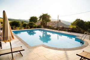 a large swimming pool in a yard at Agriturismo Girolomoni - Locanda in Isola del Piano