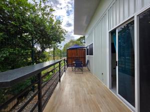 a balcony with a view of a house at Ocean Breeze at Life's a Beach in Uvita