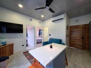 a living room with a couch and a ceiling fan at Ocean Breeze at Life's a Beach in Uvita