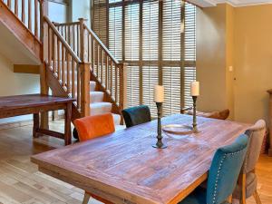a dining room with a wooden table and chairs at Church Barn in Olney