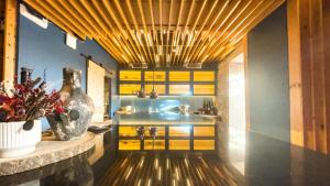 a kitchen with yellow cabinets and a vase on a counter at PipaD'oro by YoursPorto in Porto +13 photos