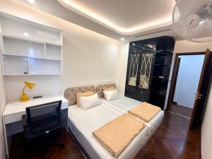 a small bedroom with a bed and a desk at Hanaco Homestay in Hai Phong +37 photos
