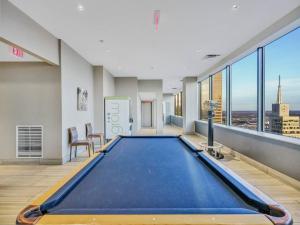 a large swimming pool in a room with windows at Luxury Apt W/Parking CityView|Pool| Gym|PoolTable in Dallas