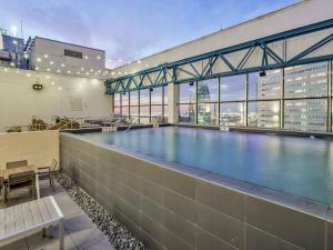 a large swimming pool in a building with a view at Luxury Apt W/Parking CityView|Pool| Gym|PoolTable in Dallas