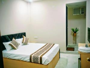 a bedroom with a bed with pillows on it at Hotel Venus in Jabalpur +32 photos