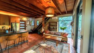 a living room with a couch and a bar at RiverHill Hideaway in Monkey Fall