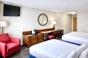 a hotel room with two beds and a desk and a chair at Islander Inn in Put-in-Bay +31 photos