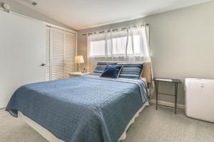 a bedroom with a blue bed and a window at Riverfront Savannah Getaway w/ Pool & Dock! in Savannah +34 photos