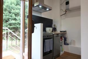 a kitchen with a stove top oven next to a window at Adishatz in Salles