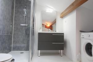 a bathroom with a shower and a sink and a toilet at Adishatz in Salles