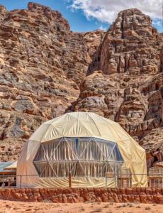 a large tent in front of a rocky mountain at Daria Luxury Camp in Wadi Rum