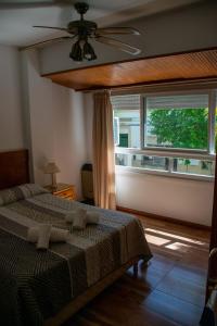 a bedroom with a bed and a large window at Continental Hotel in Miramar