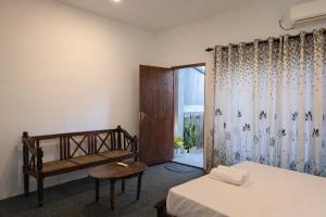 a bedroom with two beds and a window at Wild Pulse Yala in Tissamaharama +32 photos
