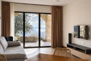 a living room with a couch and a large glass door at El Balcón de Potes in Potes