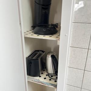 a corner of a pantry with a coffee maker and a blender at Red Dot Apartment Bruno in Werne an der Lippe