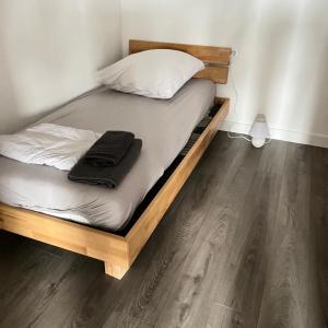 a bed in a room with a wooden bed frame at Red Dot Apartment Bruno in Werne an der Lippe