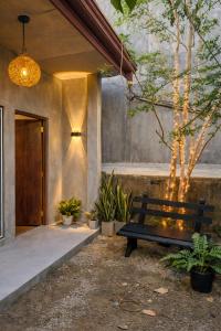 a wooden bench sitting in front of a building at Wild Pulse Yala in Tissamaharama