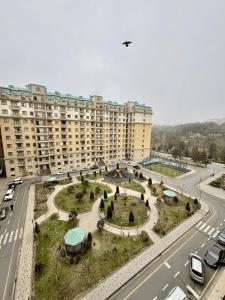 an aerial view of a large apartment building with a park at Sumgayit Apart House in Sumqayıt +12 photos
