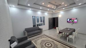 a living room with a couch and a table at Suhail Star Guest House in Misfāh