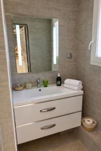 a bathroom with a white sink and a mirror at Château Gombert in Marseille