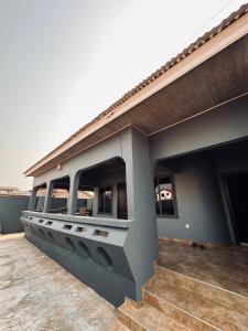 a side view of a building with a porch at C&B House MV in Accra