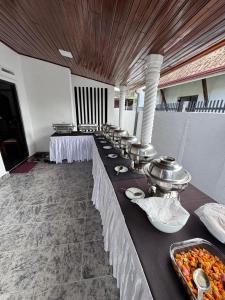 a row of tables with food on them at Vintage Voyage Villa in Negombo