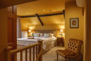 a bedroom with a bed and a chair at Morston Hall in Holt