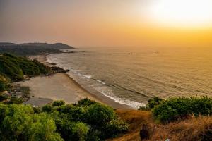 a view of the beach at sunset at Tim's Place Anjuna beach in Anjuna