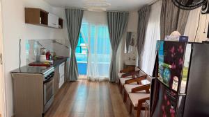 a kitchen with a refrigerator and a dining room at Mayooram Back water Pool Villa in Kollam