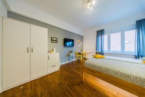 a bedroom with a bed and a large window at Flex SelfCheckIns 209 - Zagreb - Studio Apartment - Centre in Zagreb +9 photos