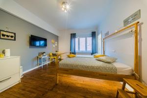 a bedroom with a bed and a desk and a tv at Flex SelfCheckIns 209 - Zagreb - Studio Apartment - Centre in Zagreb