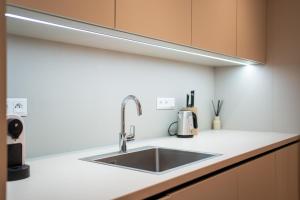 a kitchen with a sink and a counter top at Vila Dolná in Banská Bystrica +97 photos
