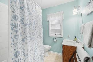 a bathroom with a toilet and a shower curtain at A Shore Thing in Douglas +20 photos