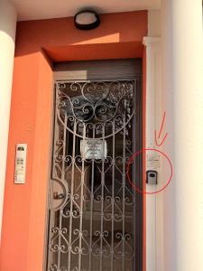 a black door with a red number on it at ZIO CESARE FOSSO' 4 int 2 in Fossò