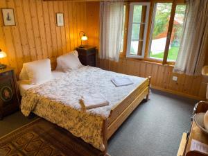 a bedroom with a bed with two towels on it at Pension Gimmelwald in Gimmelwald