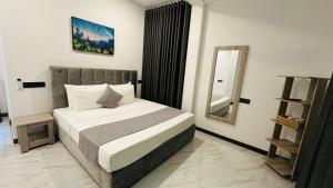 a bedroom with a bed and a mirror in it at EK Breeze Kalutara in Kalutara