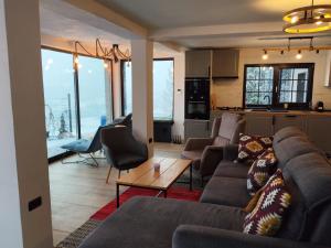 a living room with a couch and a table at Loft Bucovina in Gura Humorului
